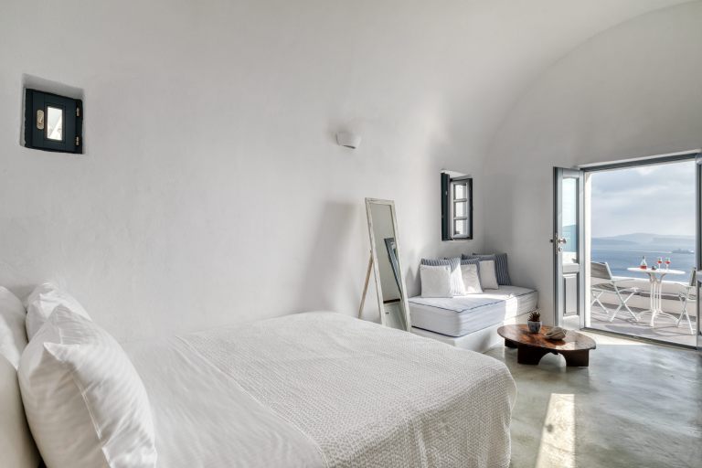 The comfortable bed inside the luxury Junior Suite of Nostos Apartments in Oia Santorini